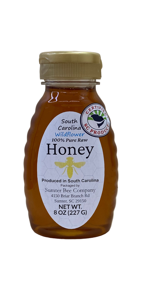 8 Oz Bottle of Sumter Bee Company South Carolina Wildflower honey with a gold cap on a white background